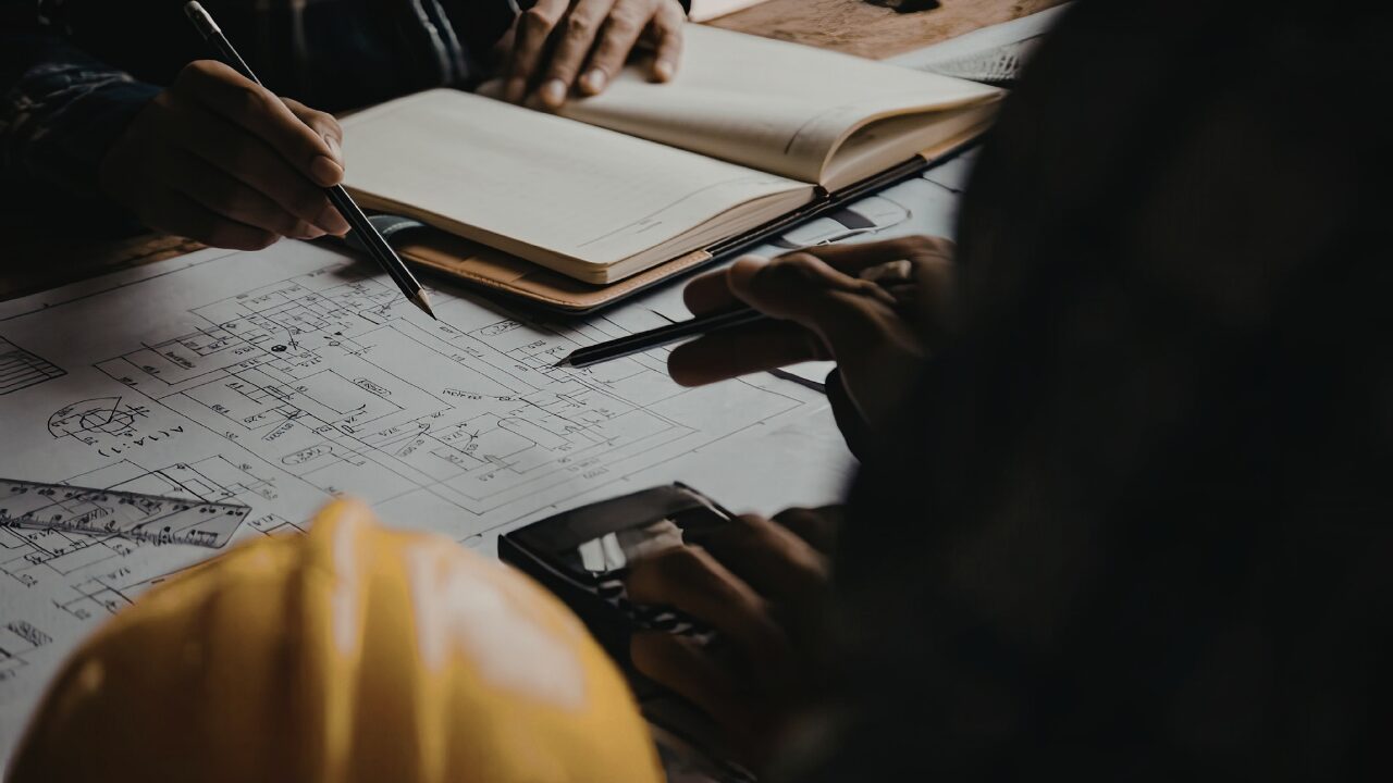 Engineers reviewing construction plans together