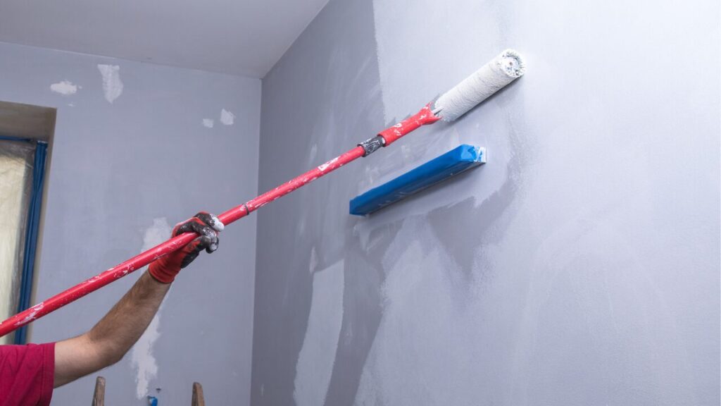 Tradesman painting an interior wall