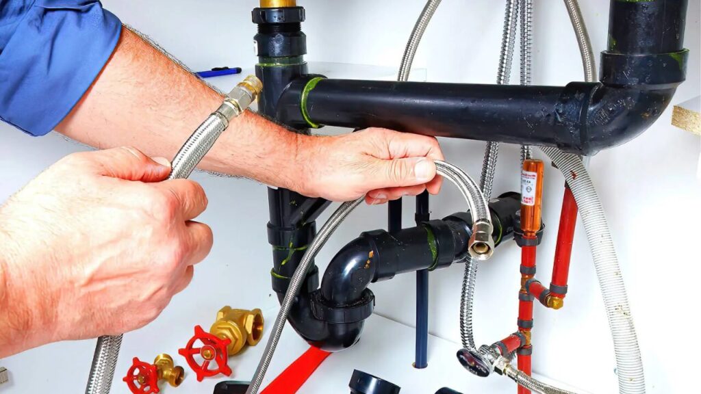 Man repairing a plumbing pipe