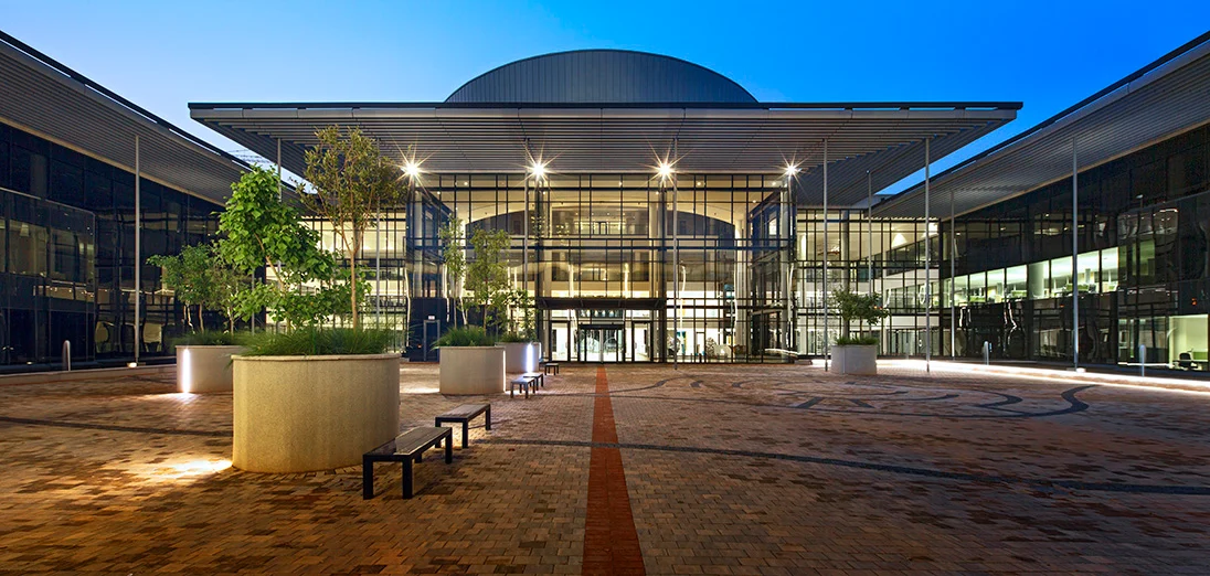 Exterior courtyard view of Tshwane House at dusk